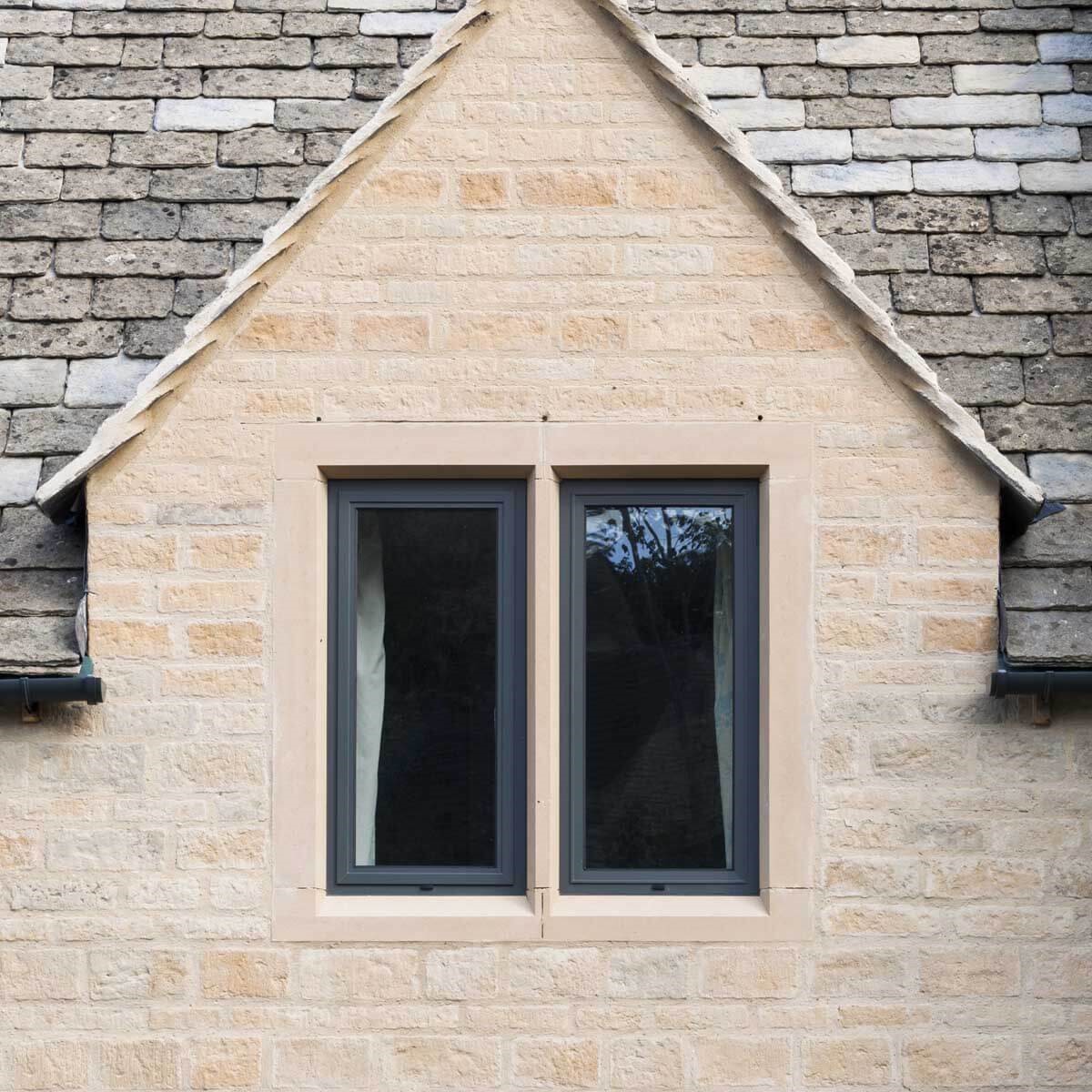 black window frame on a brick house
