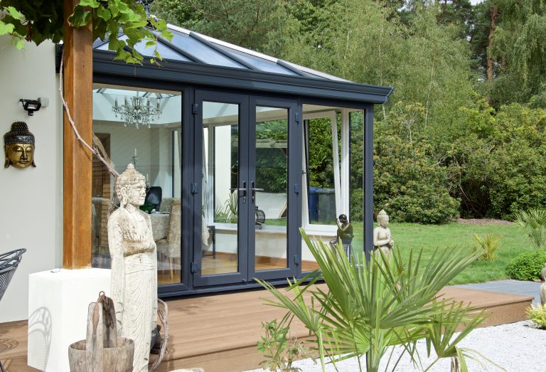 Closed black conservatory in zen garden.